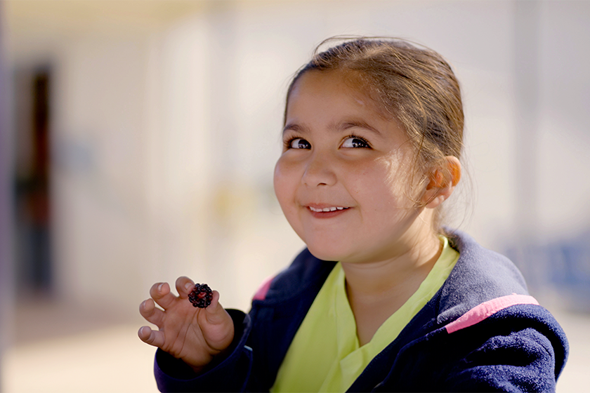 student eating berry