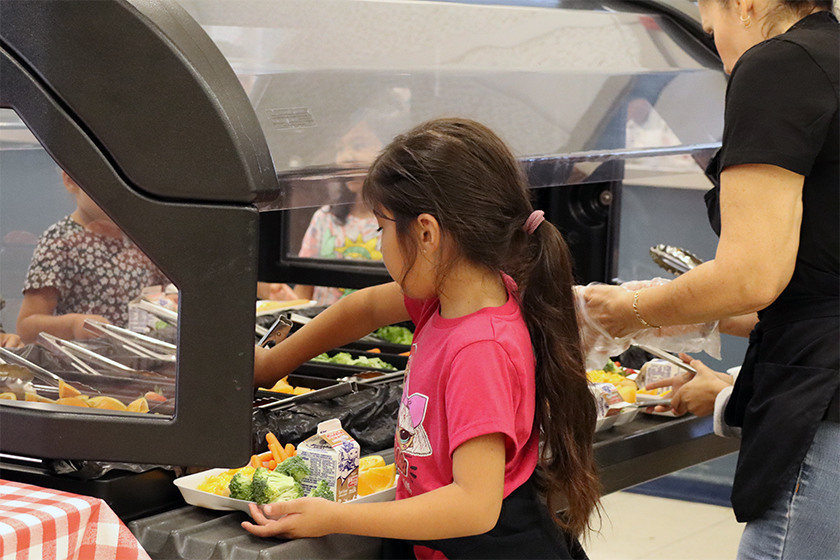 student at salad bar