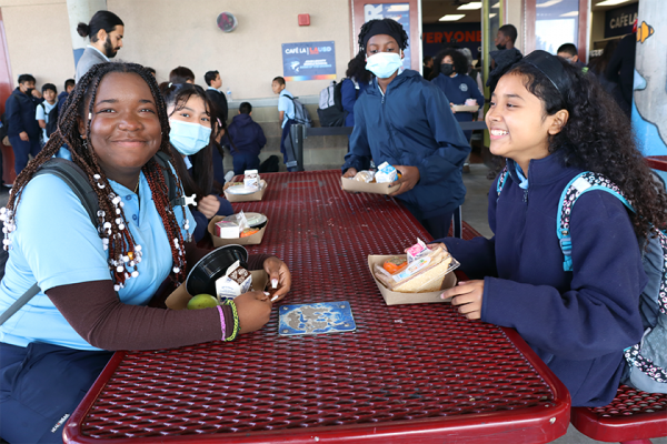 students sit at lunch table