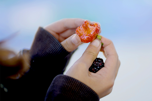 student holds strawberry