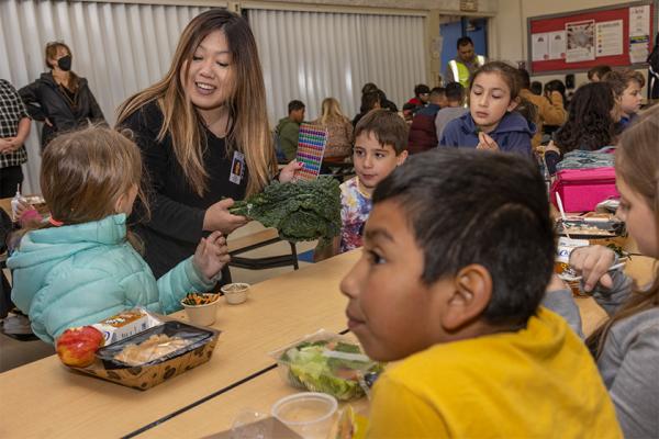 Jennifer Lew Vang with students at lunch table