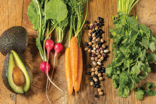 avocado radish carrot bean cilantro on wood