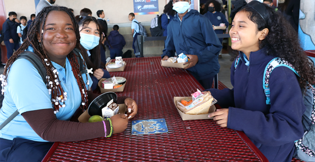 students sit at lunch table