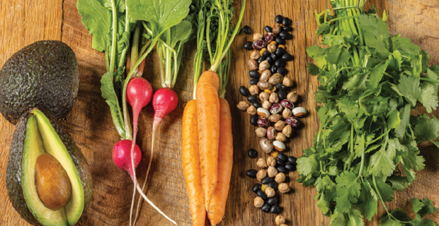 avocado radish carrot bean cilantro on wood