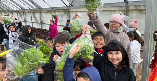 students holding lettuce